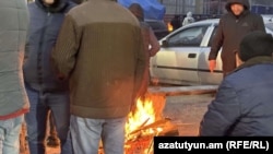 Armenia - Striking workers huddle around a bonfire in Kajaran, February 5, 2025.