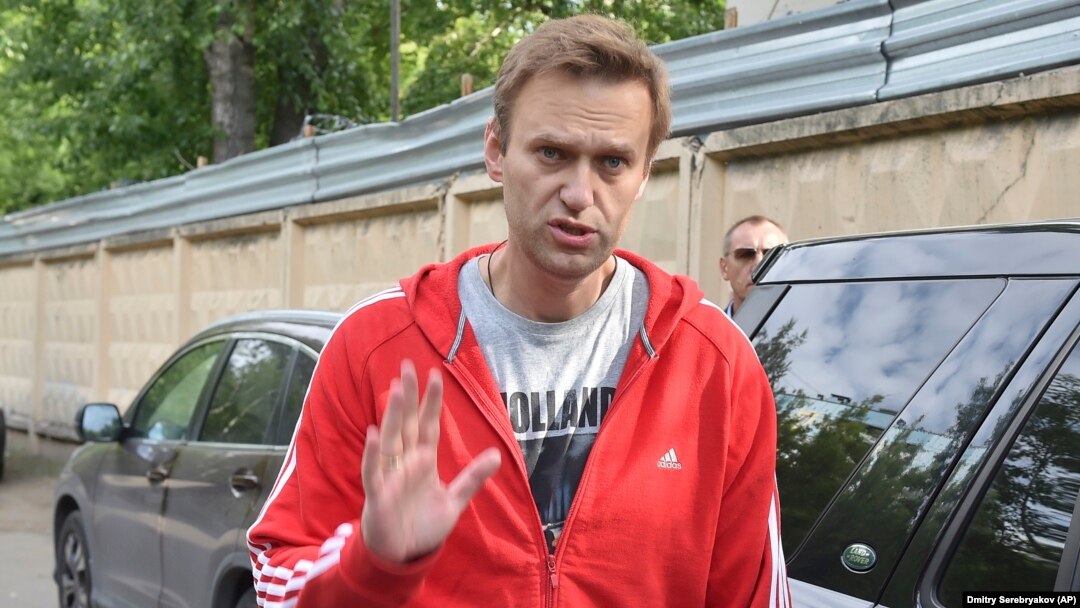 Aleksei Navalny greets colleagues as he leaves a detention center in Moscow on June 14.