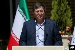 Abdolnasser Hemmati speaks with state-run TV journalists upon arrival for the second debate of the candidates in Tehran on June 8.