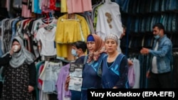 Трудовые мигранты на рынке в Москве (Россия).