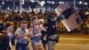 Riot police detain a group of demonstrators during a protest after polls closed in Belarus's presidential election in Minsk on August 9, 2020. 