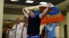 Russian soccer-fan leader Aleksandr Shprygin holds a flag as he leaves Moscow with others fans for Euro 2016.