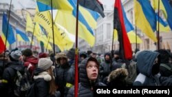 People attend a rally in front of the Ukrainian parliament on January 16, calling for lawmakers to recognize Russia as an aggressor state and implement other legislative changes concerning the occupied parts of eastern Ukraine. 