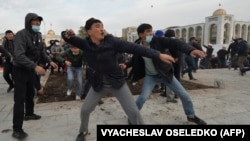 Supporters of Sadyr Japarov throw clumps of dirt toward supporters of former Kyrgyz President Almazbek Atambayev as they attend a rally in Bishkek on October 9.