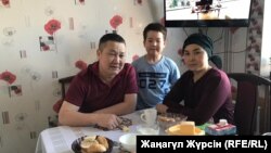 Sanat Dosov (left) is back home with his wife and son on December 11.