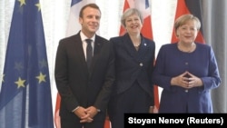 French President Emmanuel Macron (left), British Prime Minister Theresa May (center), and German Chancellor Angela Merkel meet during the EU-Western Balkans Summit in Sofia on May 17.