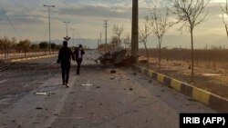 A photo made available by Iranian state TV shows the damaged car of nuclear scientist Mohsen Fakhrizadeh after it was attacked near the capital, Tehran, on November 27.