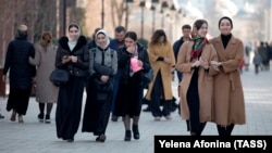 Women walk through a street in the Chechen capital of Grozny. Domestic violence has been a problem in Russia's North Caucasus region for decades.