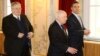 Greek Foreign Minister Nikos Kotzias (left), UN envoy Matthew Nimetz (center), and Macedonian Foreign Minister Nikola Dimitrov arrive for talks in Vienna on March 30.