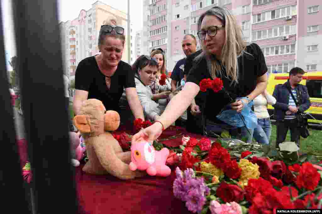 A woman places a toy at a makeshift memorial for victims of the shooting at Kazan's School No. 175 on May 11.