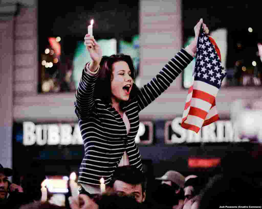A New Yorker celebrates the news of bin Laden’s killing. After a DNA test on the Al-Qaeda leader’s corpse confirmed his identity, he was buried by U.S. forces at sea within 24 hours of his death, per Islamic custom. 