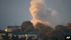 Smoke rises after shelling in Nagorno-Karabakh's main city, Stepanakert, on October 29.