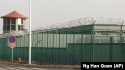 A guard tower and barbed wire fences surround an internment facility in the Kunshan Industrial Park which has previously been revealed by leaked documents to be a forced indoctrination camp in Artux in western China's Xinjiang region. (File photo)