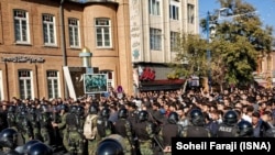 Riot police confront protesters in the Iranian city of Urmia on November 16.