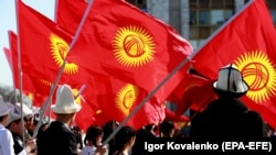 People wave Kyrgyz flags in Bishkek. (file photo)