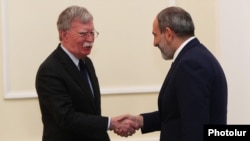 Acting Armenian Prime Minister Nikol Pashinian (right) with U.S. national-security adviser John Bolton in Yerevan on October 25.