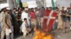 Pakistani protestors burn a Danish flag on 2 February.