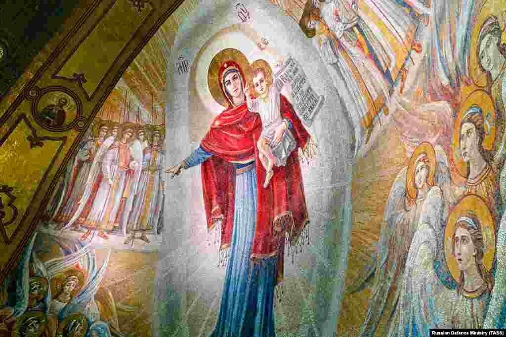 One of the numerous mosaics inside the cathedral shows Jesus being held by his mother, Mary. On April 24, the Russian news outlet MBK published leaked photos of unfinished mosaics inside the cathedral depicting Soviet leader Josef Stalin, Russian President Vladimir Putin, and scenes from Russia’s 2014 takeover and annexation of Ukraine's Crimean Peninsula.